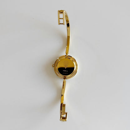 Gucci 1990s Interchangeable Bezel Gold Plated Bangle Watch with 12 bezels, case