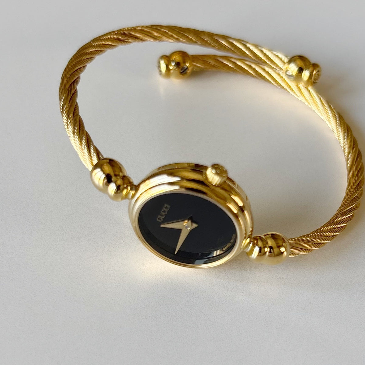 Gucci 1990s Black Round Dial Cable Gold-Plated Bangle Watch
