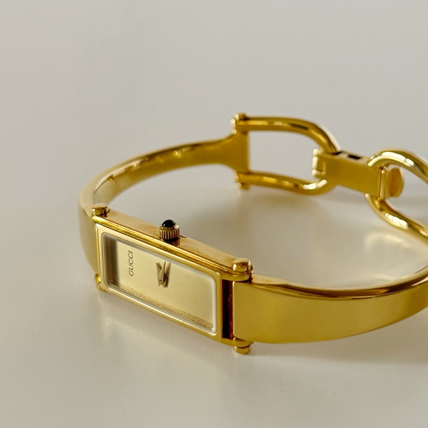 Gucci 1990s Rectangular Gold Dial Gold Plated Bangle Watch
