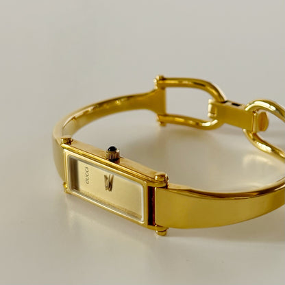 Gucci 1990s Rectangular Gold Dial Gold Plated Bangle Watch