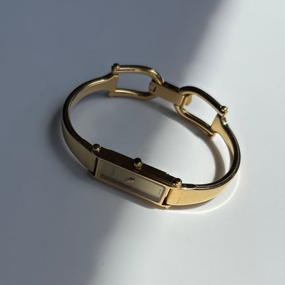Gucci 1990s Rectangular Gold Dial Gold Plated Bangle Watch