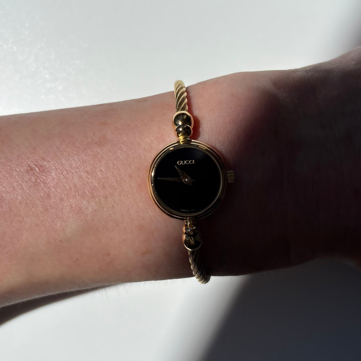 Gucci 1990s Black Round Dial Cable Gold-Plated Bangle Watch
