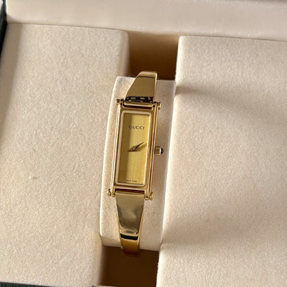 Gucci 1990s Rectangular Gold Dial Gold Plated Bangle Watch