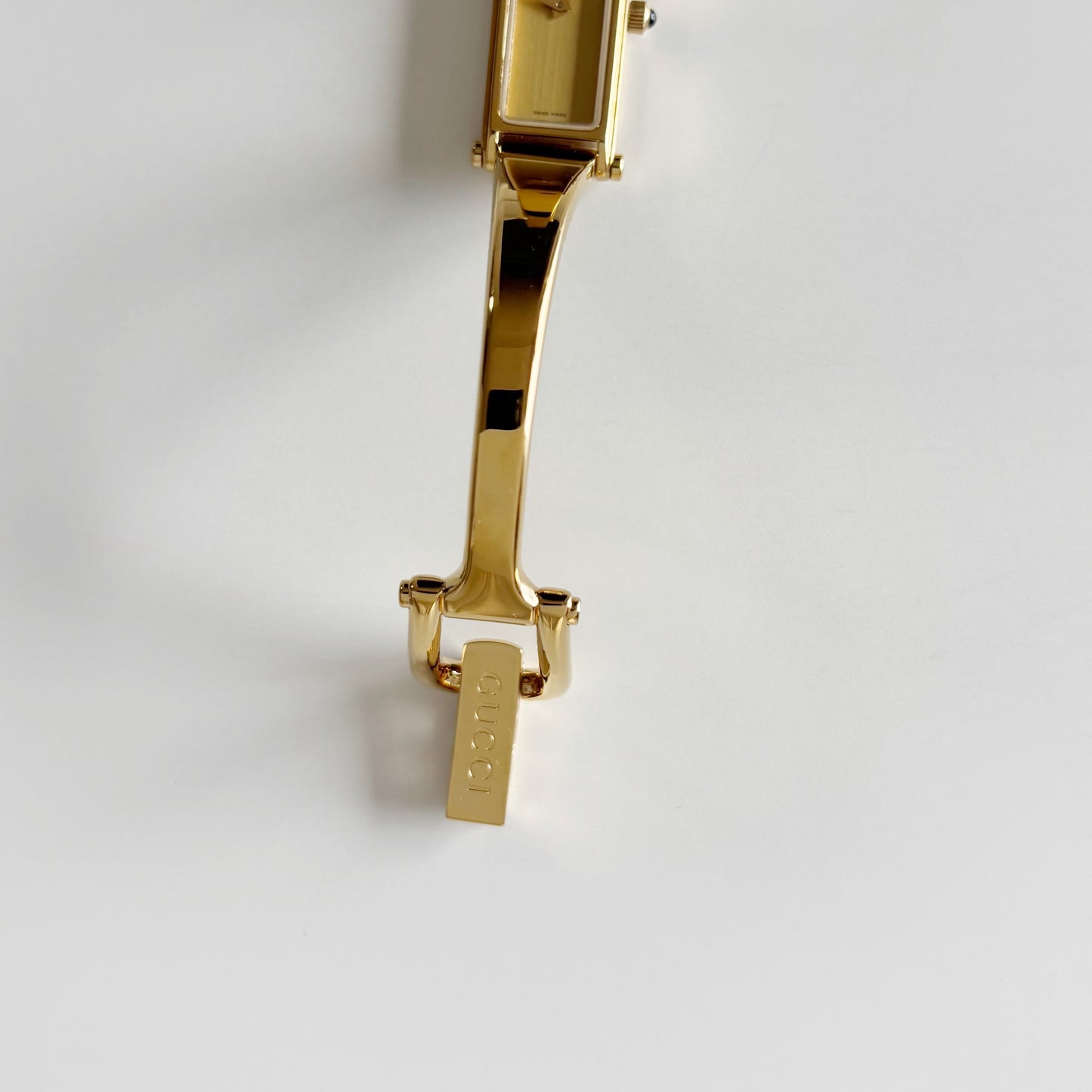 Gucci 1990s Rectangular Gold Dial Gold Plated Bangle Watch