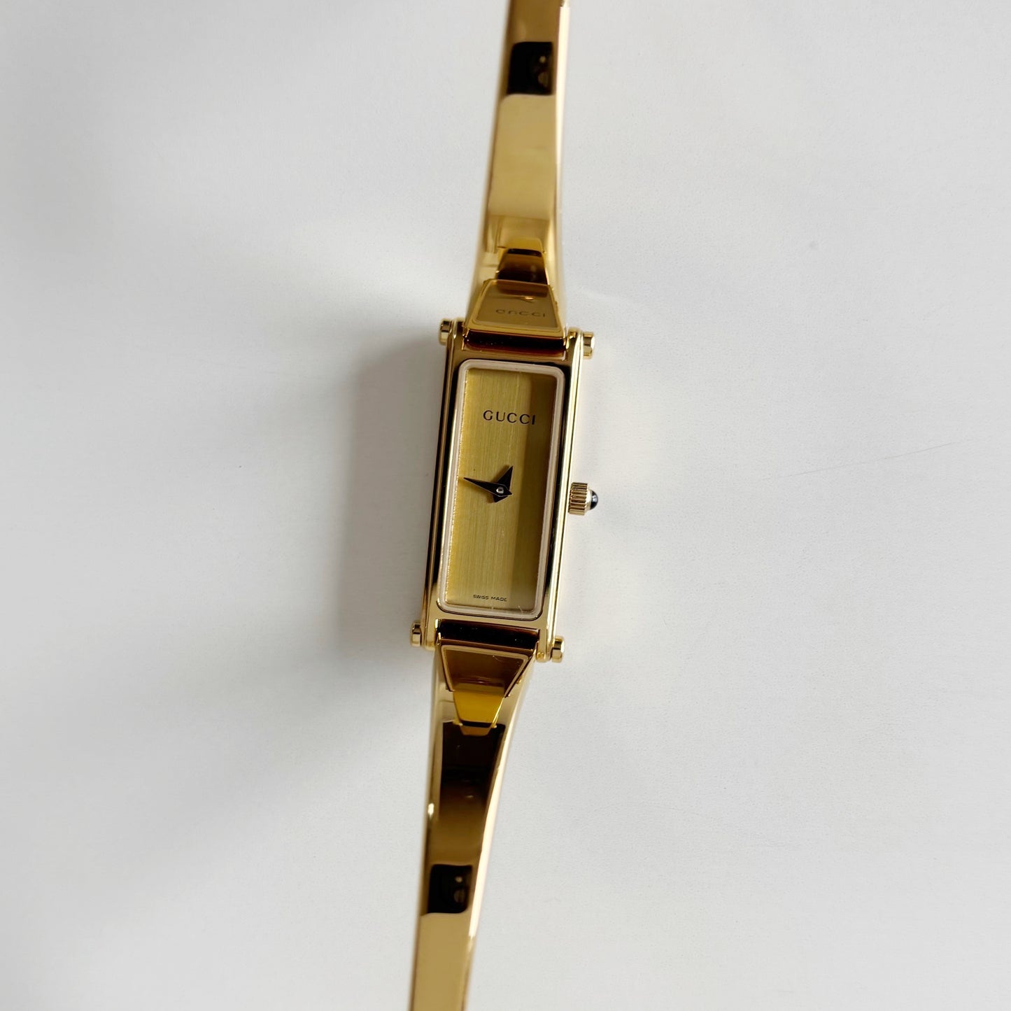 Gucci 1990s Rectangular Gold Dial Gold Plated Bangle Watch