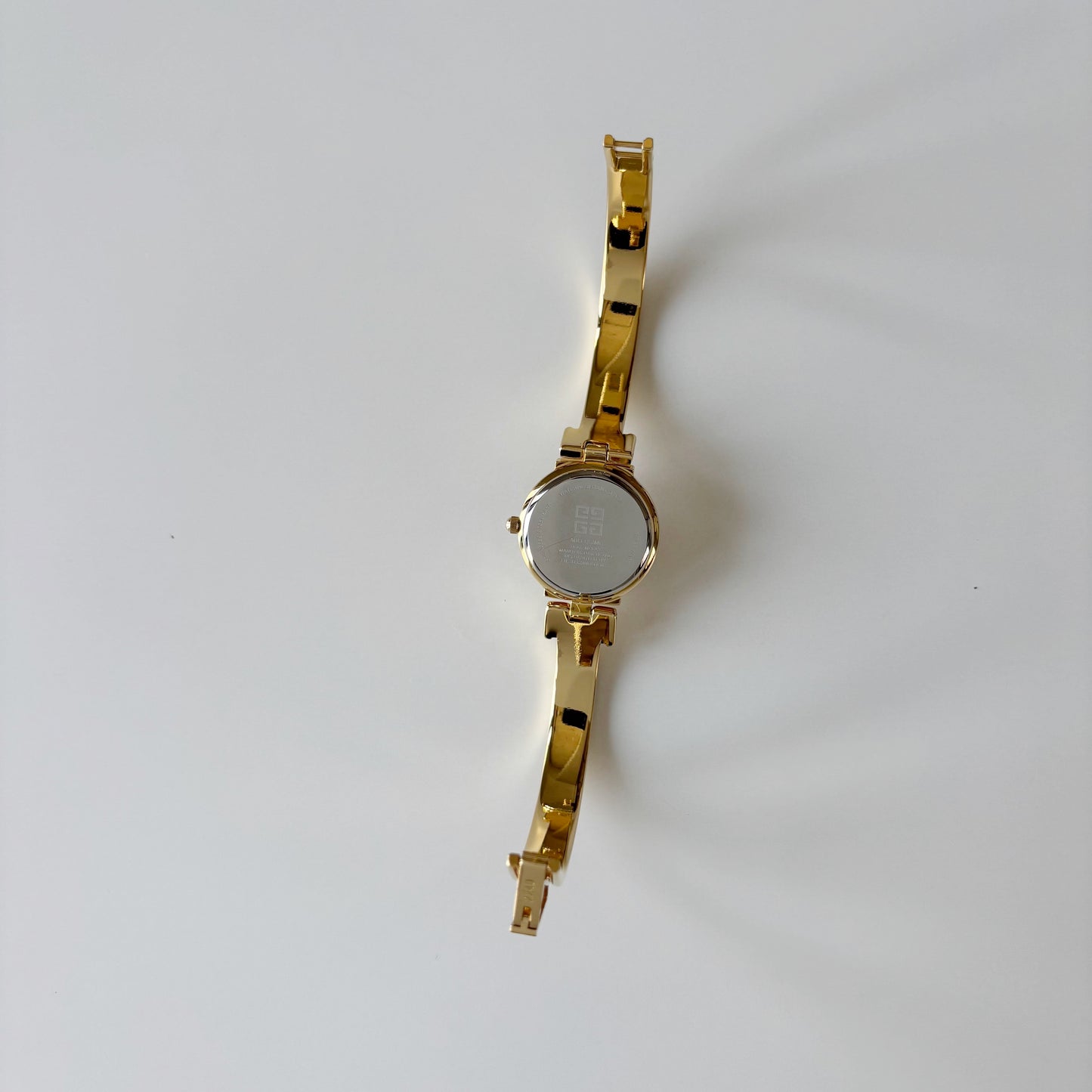 Givenchy 1990s Black Round Dial Gold Plated Bangle Watch