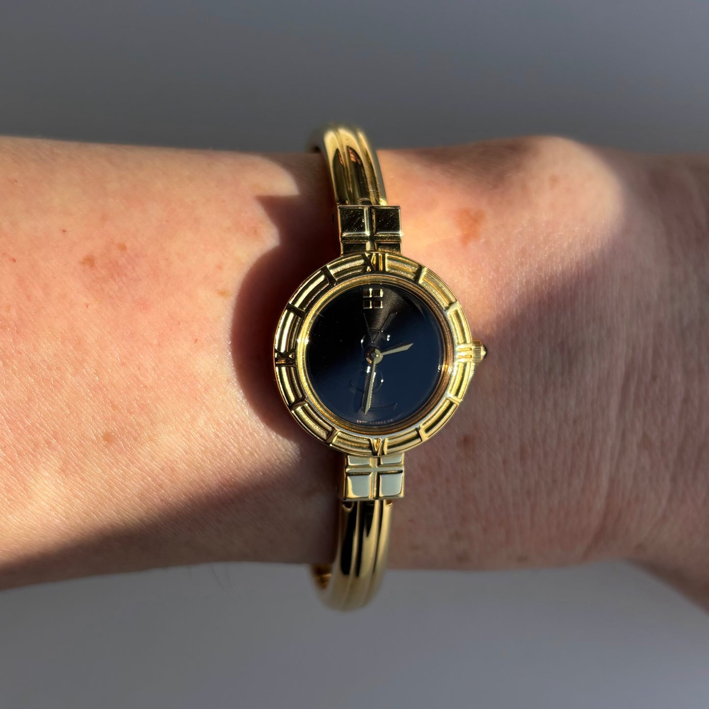 Yves Saint Laurent 1990s Black Round Dial Gold Plated Bangle Watch