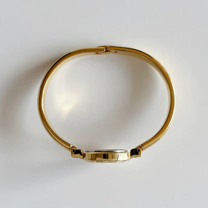 Yves Saint Laurent 1990s Black Round Dial Gold Plated Bangle Watch