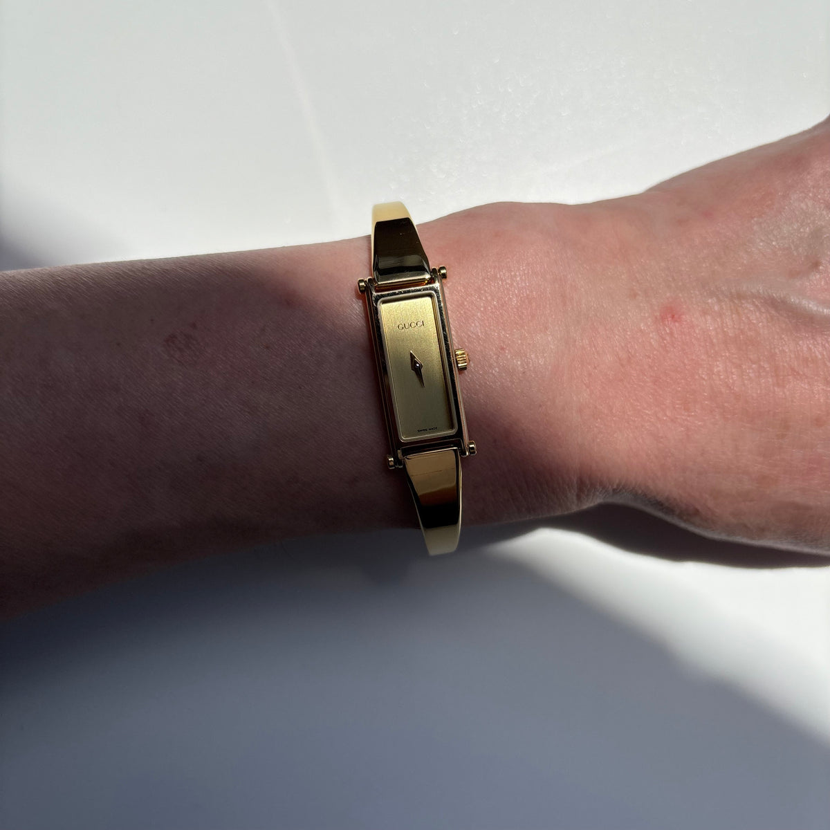Gucci 1990s Rectangular Gold Dial Gold Plated Bangle Watch (Small)
