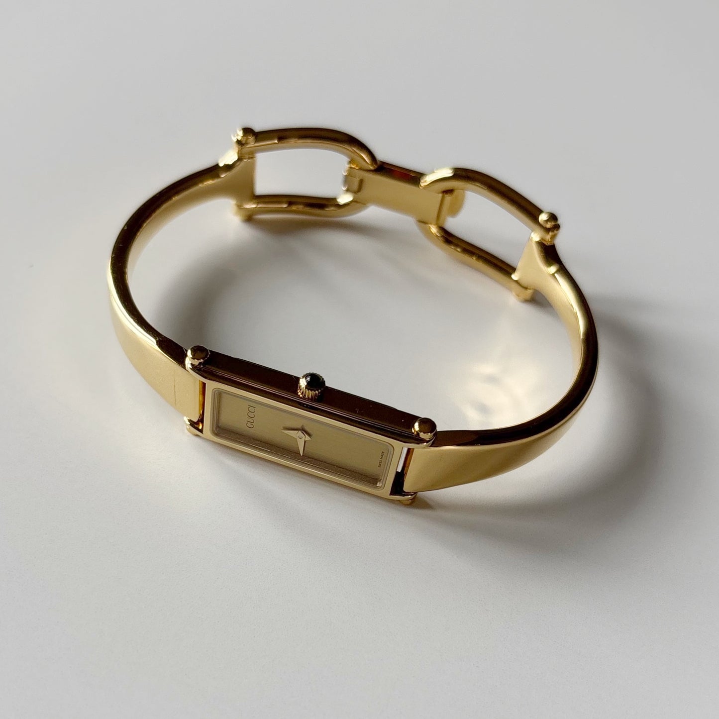 Gucci 1990s Gold Rectangular Dial Gold Plated Bangle Watch