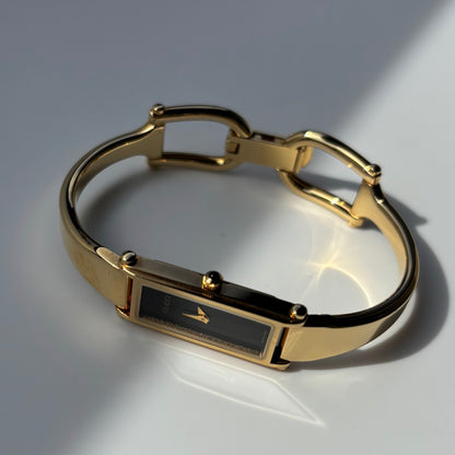 Gucci 1990s Rectangular Black Dial Gold Plated Bangle Watch