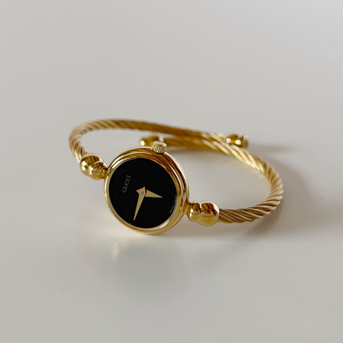 Gucci 1990s Black Round Dial Cable Gold-Plated Bangle Watch