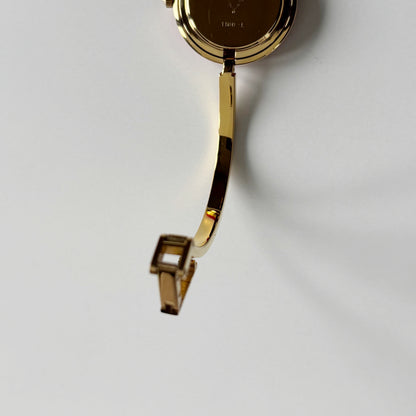 Gucci 1990s Interchangeable Bezel Gold Plated Bangle Watch with 12 bezels, case