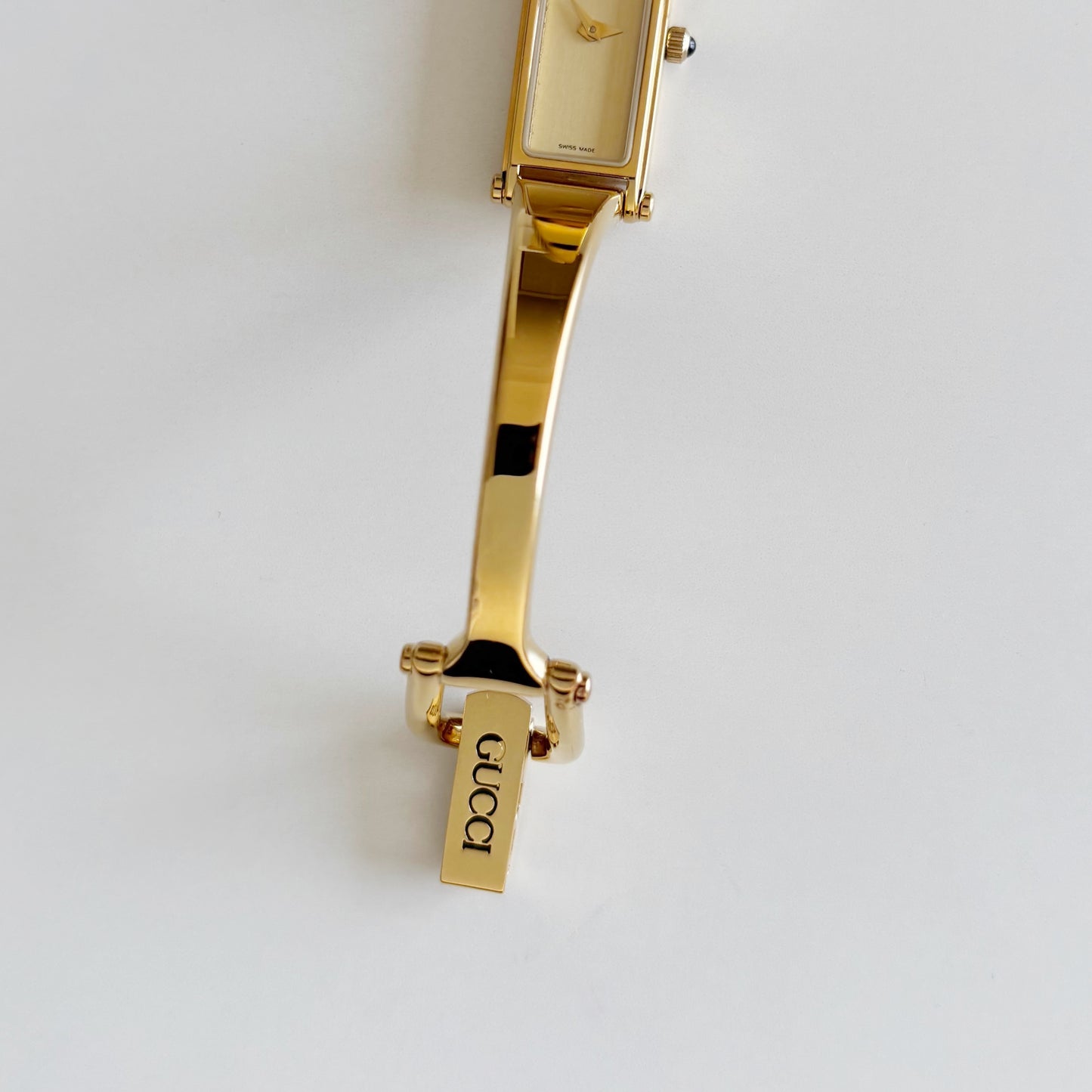 Gucci 1990s Rectangular Gold Dial Gold Plated Bangle Watch