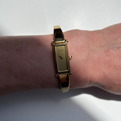 Gucci 1990s Rectangular Gold Dial Gold Plated Bangle Watch