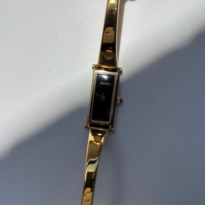 Gucci 1990s Black Rectangular Dial Gold Plated Bangle Watch