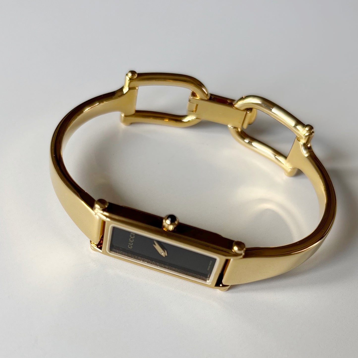 Gucci 1990s Black Rectangular Dial Gold Plated Bangle Watch