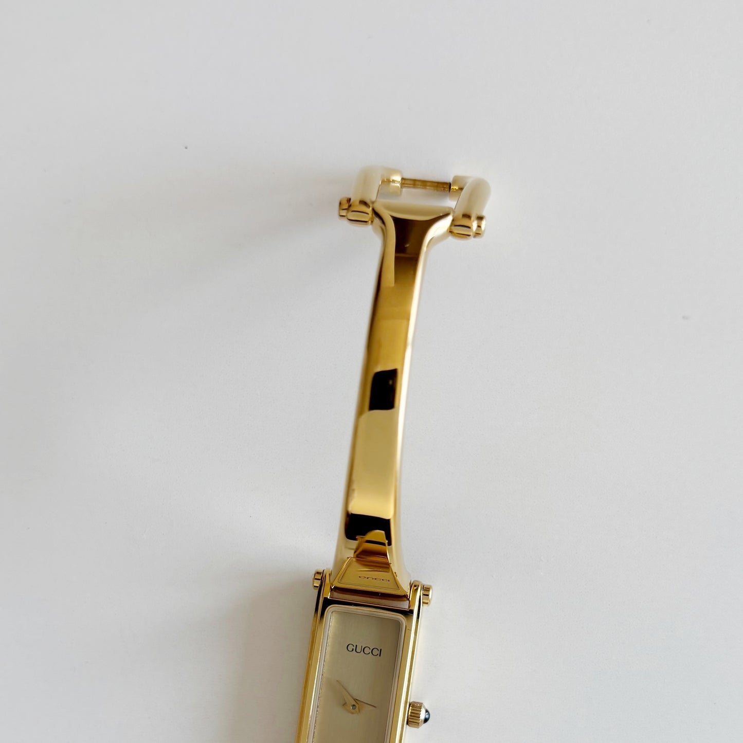 Gucci 1990s Rectangular Gold Dial Gold Plated Bangle Watch