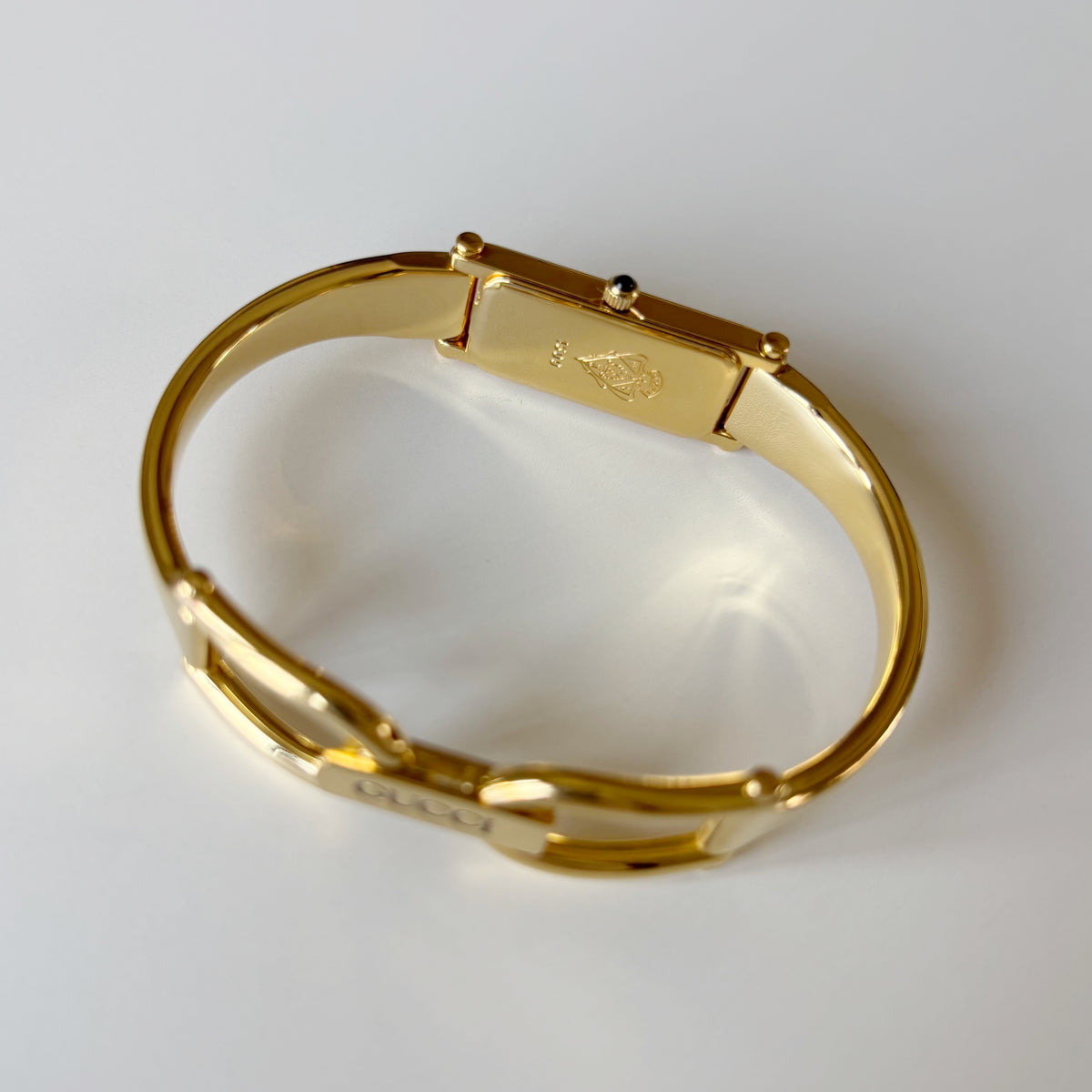 Gucci 1990s Rectangular Gold Dial Gold Plated Bangle Watch