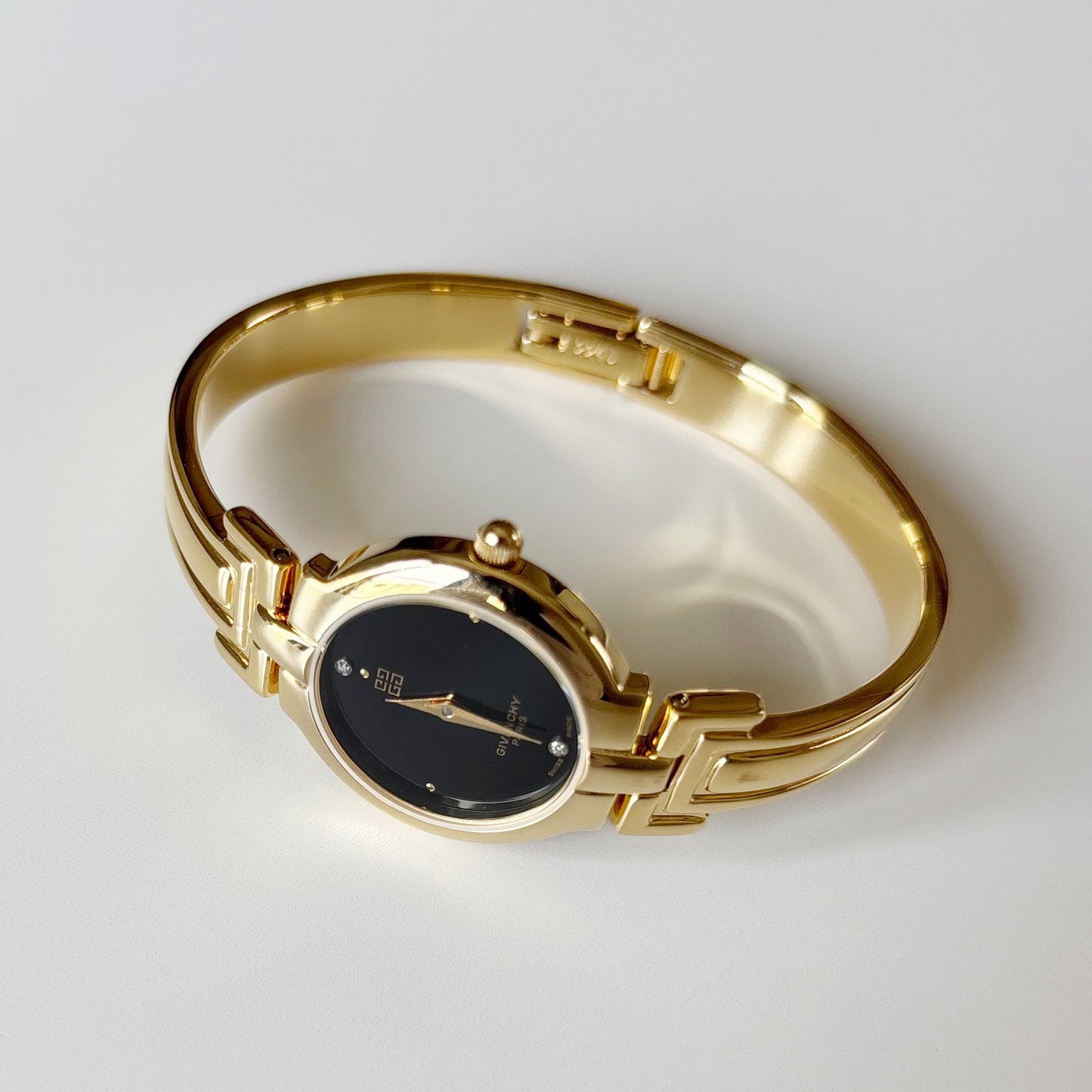 Givenchy 1990s Black Round Dial Gold Plated Bangle Watch