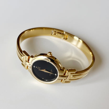 Givenchy 1990s Black Round Dial Gold Plated Bangle Watch