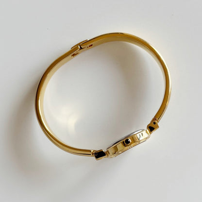 Yves Saint Laurent 1990s Black Round Dial Gold Plated Bangle Watch