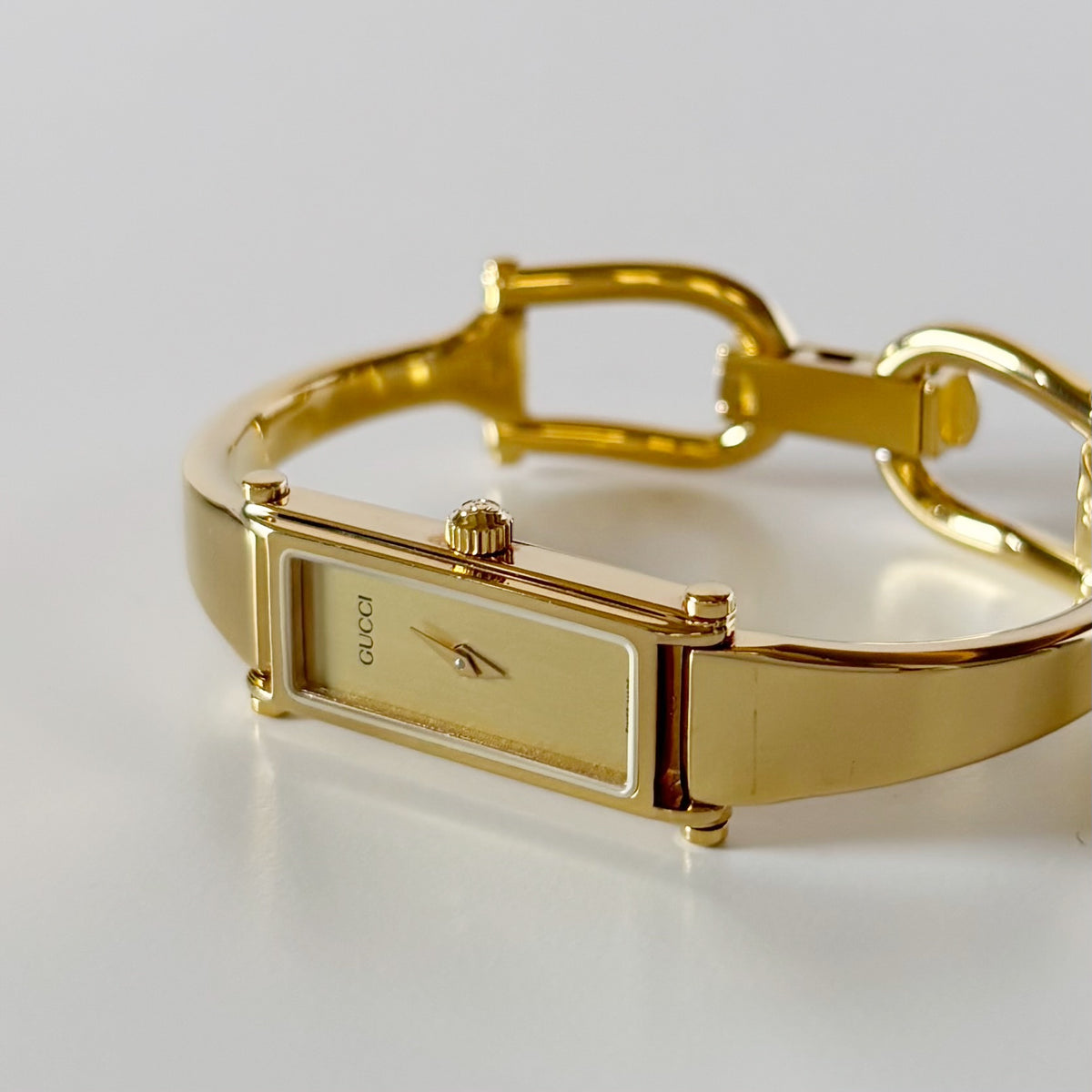 Gucci 1990s Rectangular Gold Dial Gold Plated Bangle Watch (Small)