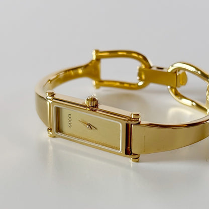 Gucci 1990s Rectangular Gold Dial Gold Plated Bangle Watch (Small)