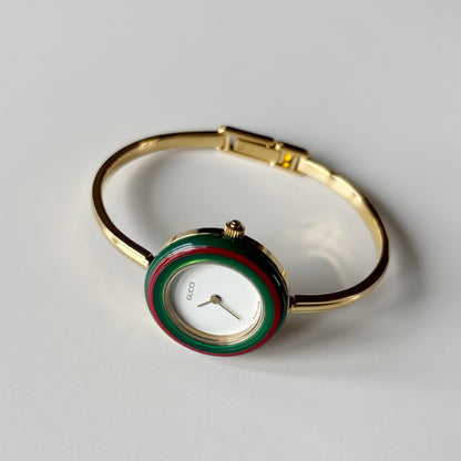 Gucci 1990s Interchangeable Bezel Gold Plated Bangle Watch with 12 bezels, case