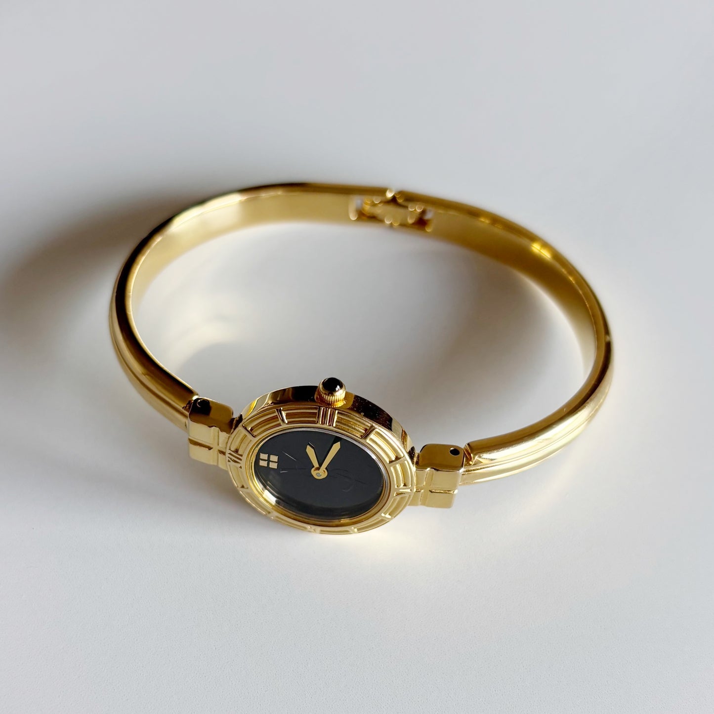 Yves Saint Laurent 1990s Black Round Dial Gold Plated Bangle Watch