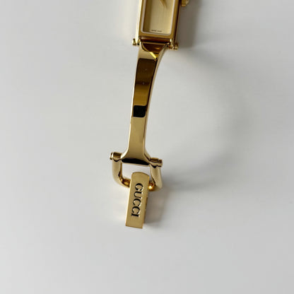 Gucci 1990s Rectangular Gold Dial Gold Plated Bangle Watch (Small)