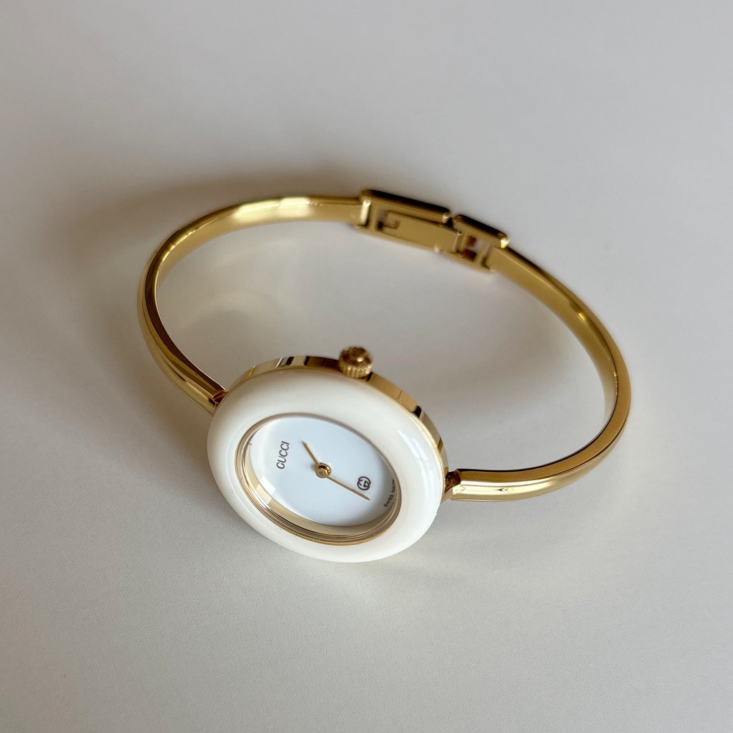 Gucci 1990s Interchangeable Bezel Gold Plated Bangle Watch with 12 bezels, case