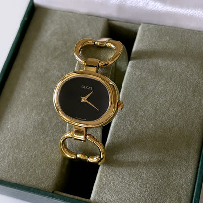 Gucci 1990s Black Dial Oval Gold Plated Bangle Watch