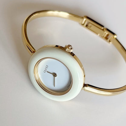 Gucci 1990s Interchangeable Bezel Gold Plated Bangle Watch with 12 bezels, case