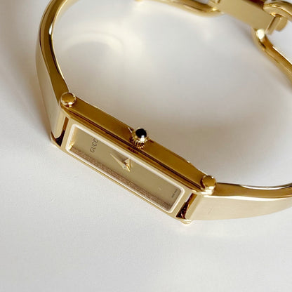 Gucci 1990s Rectangular Gold Dial Gold Plated Bangle Watch