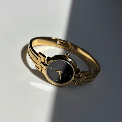 Givenchy 1990s Black Round Dial Gold Plated Bangle Watch