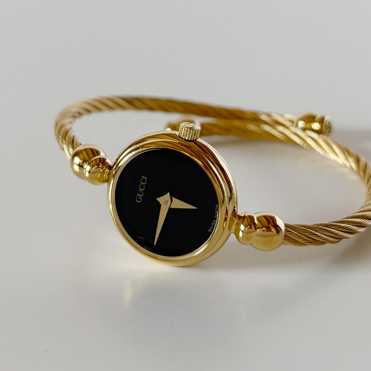 Gucci 1990s Black Round Dial Cable Gold-Plated Bangle Watch