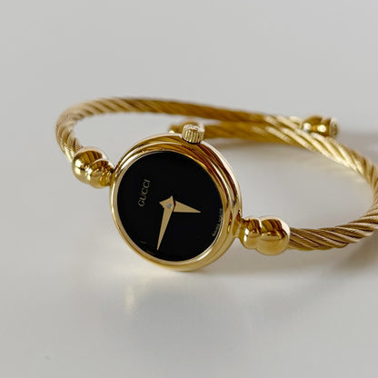 Gucci 1990s Black Round Dial Cable Gold-Plated Bangle Watch