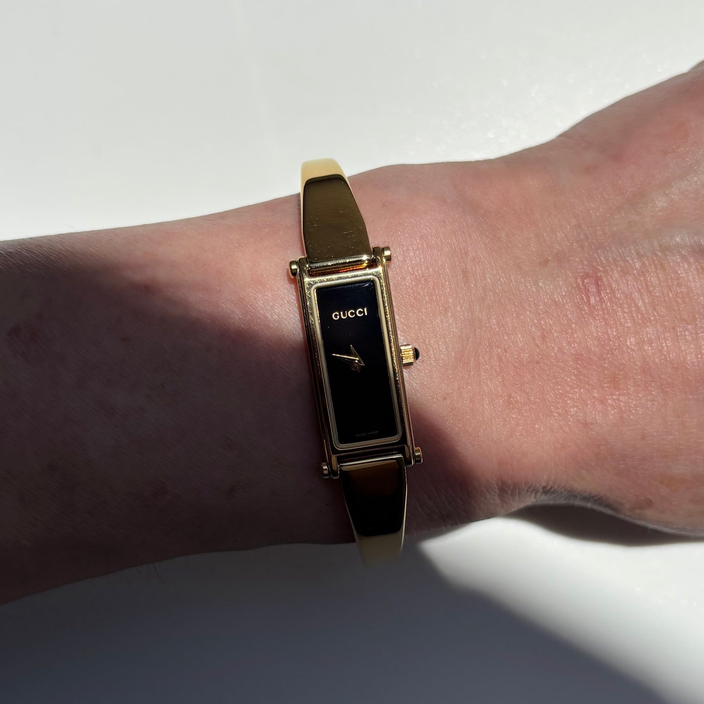 Gucci 1990s Black Rectangular Dial Gold Plated Bangle Watch