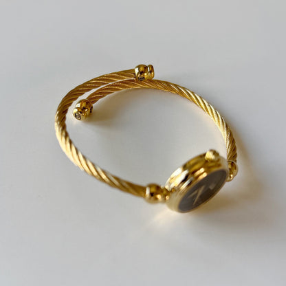Gucci 1990s Black Round Dial Cable Gold-Plated Bangle Watch