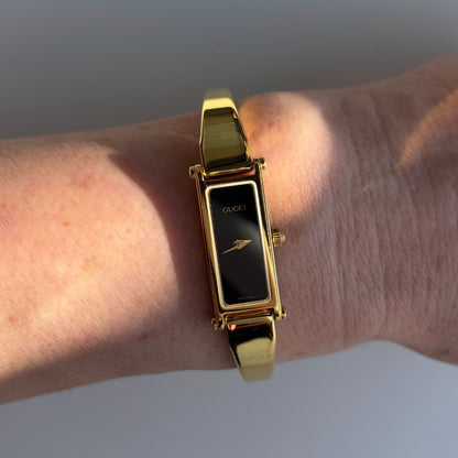 Gucci 1990s Black Rectangular Dial Gold Plated Bangle Watch