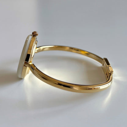 Gucci 1990s Interchangeable Bezel Gold Plated Bangle Watch with 12 bezels, case