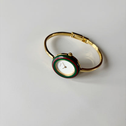 Gucci 1990s Interchangeable Bezel Gold Plated Bangle Watch with 12 bezels, case