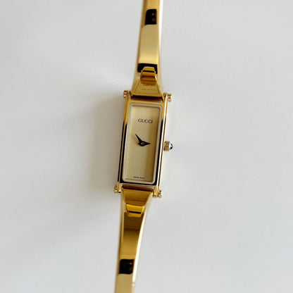 Gucci 1990s Rectangular Gold Dial Gold Plated Bangle Watch