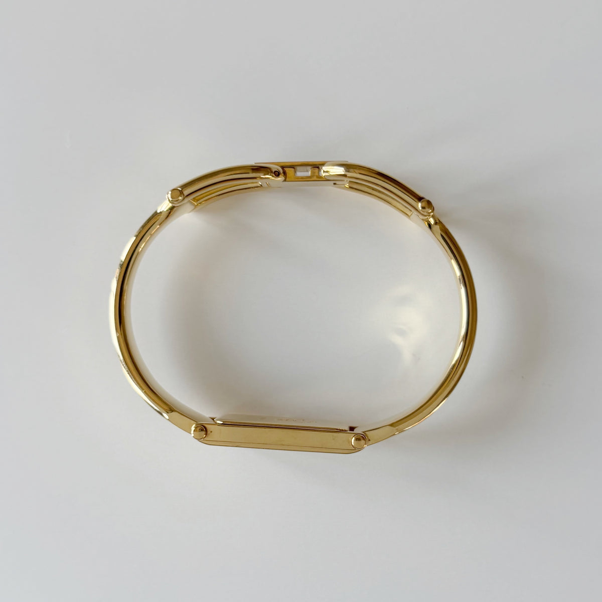 Gucci 1990s Rectangular Gold Dial Gold Plated Bangle Watch