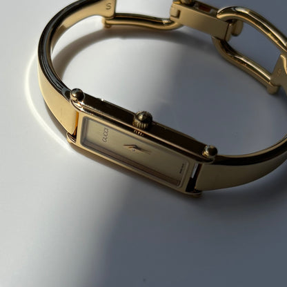 Gucci 1990s Rectangular Gold Dial Gold Plated Bangle Watch (Small)