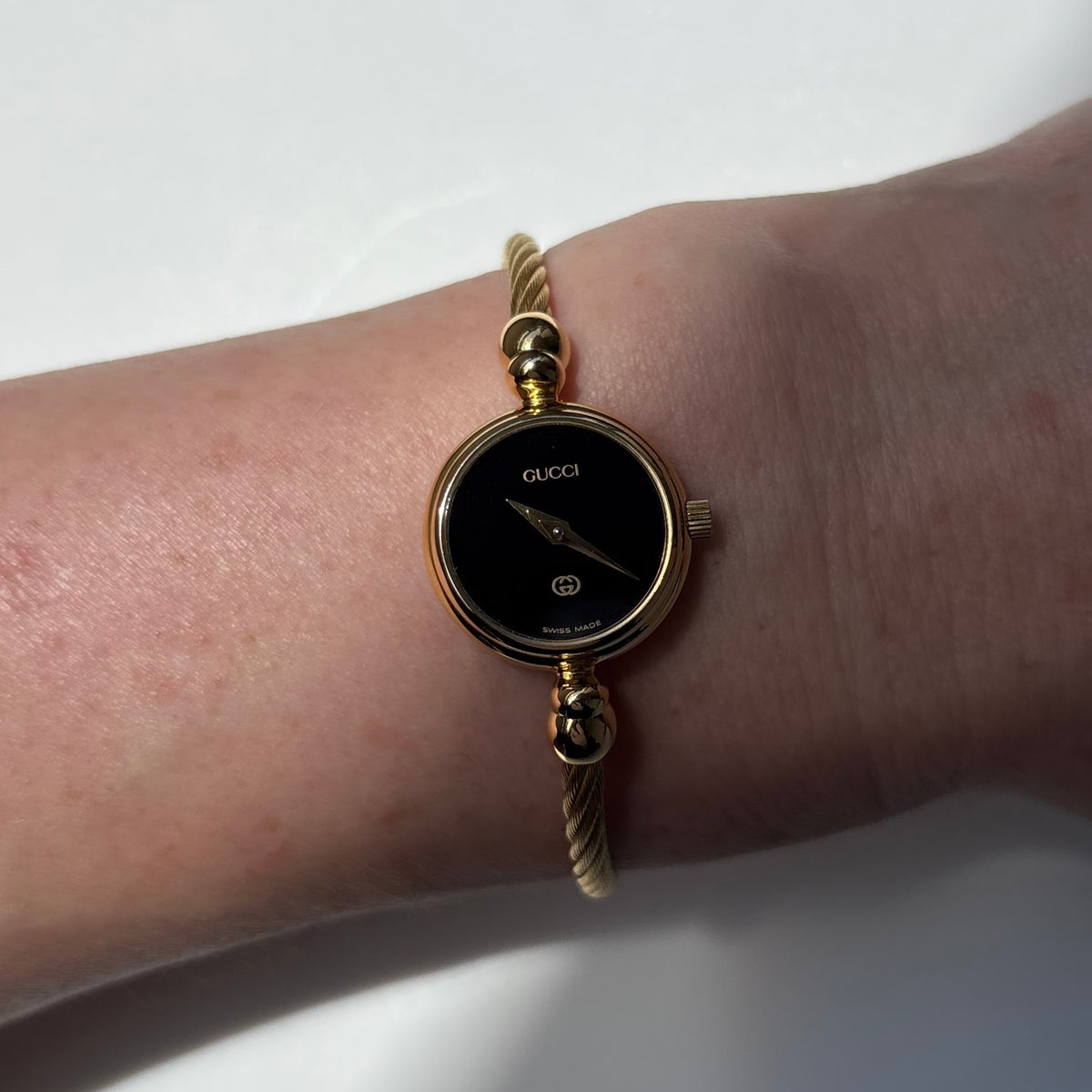 Gucci 1990s Black Round Dial Cable Gold Plated Bangle Watch