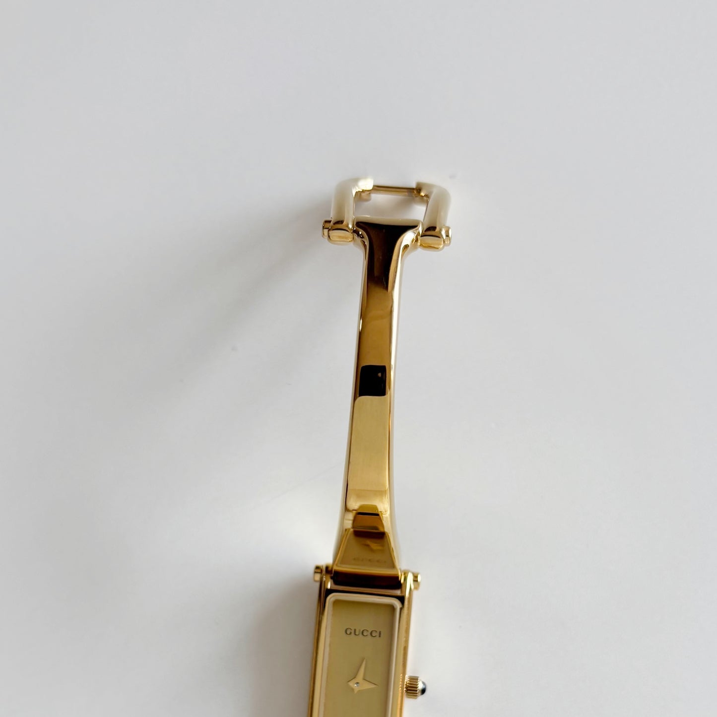 Gucci 1990s Rectangular Gold Dial Gold Plated Bangle Watch