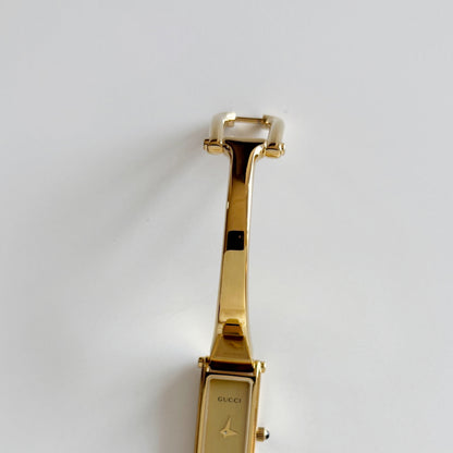 Gucci 1990s Rectangular Gold Dial Gold Plated Bangle Watch