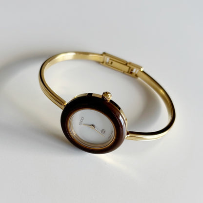 Gucci 1990s Interchangeable Bezel Gold Plated Bangle Watch with 12 bezels, case